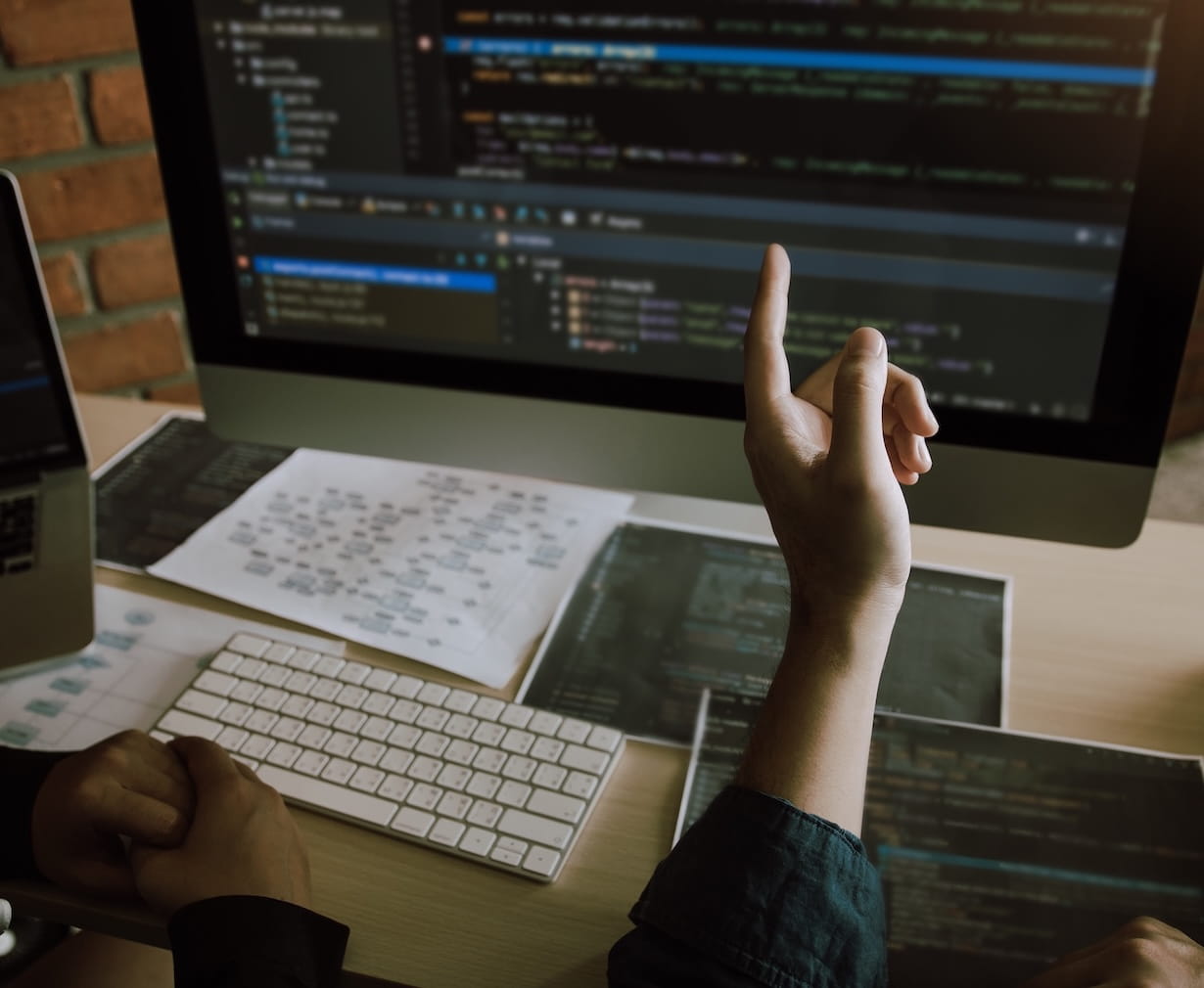 Photo of custom application developers debugging code